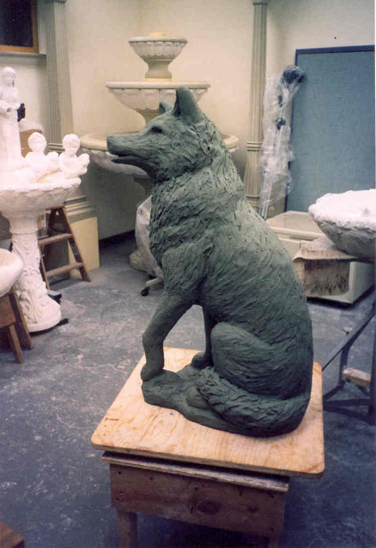 Styrofoam is now covered in clay, showing the Wolf's form. 